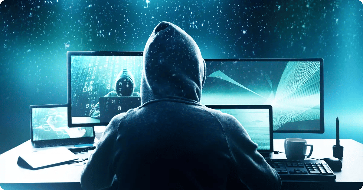 Ein Hacker vor mehreren Bildschirmen